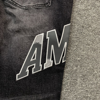 AMIRI VARSITY LOGO REPAIR JEANS